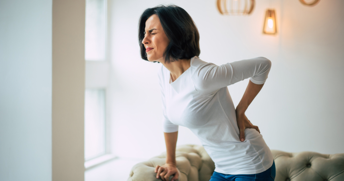 common-causes-of-chronic-pain Person experiencing persistent lower back pain, illustrating common causes of chronic pain and the need for medical evaluation.