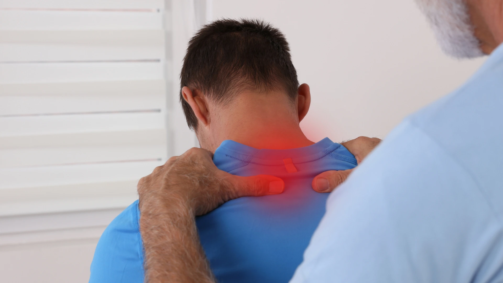 Healthcare professional providing chiropractic care to a patient with neck pain while comparing physical therapy and chiropractic treatment options.